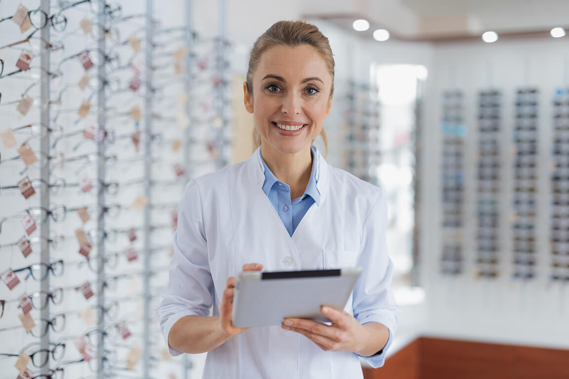 A practice manager, cheerfully welcoming their patients